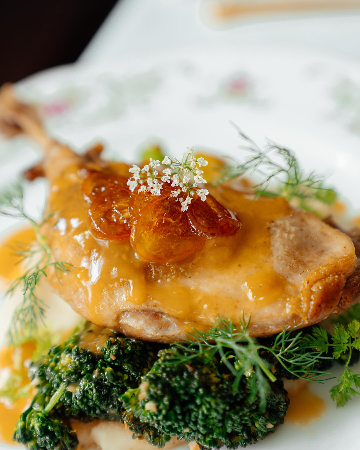 A French main course with stone fruit, herbs and greens