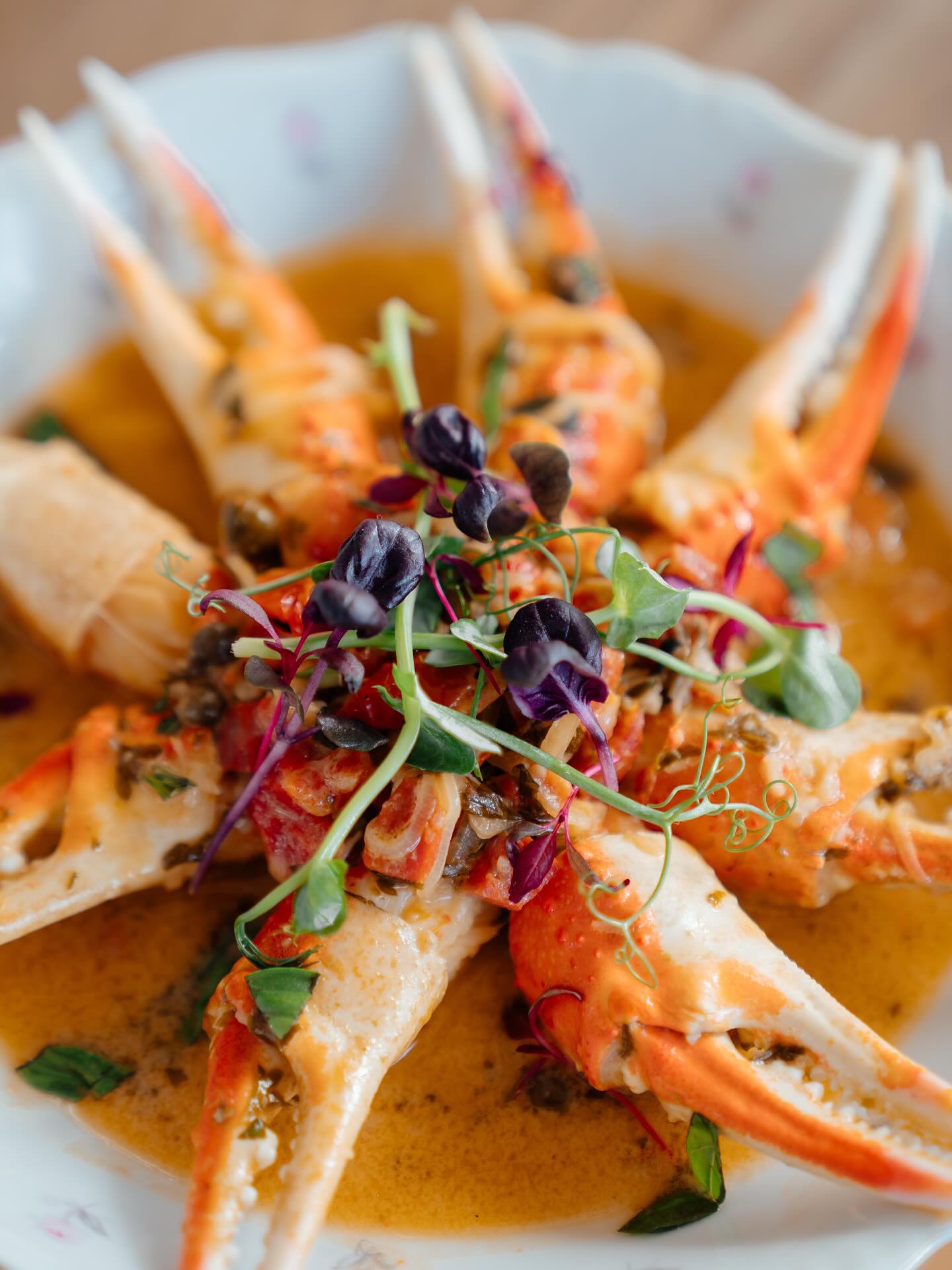 Crab claws in a butter sauce with herbs and micro leaves